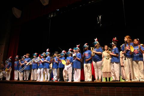 A row of Music Man band characters holding instruments, playing them.