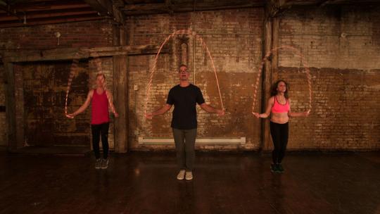 Three people jumping rope