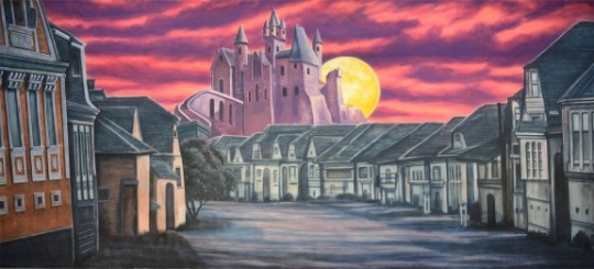 Village with scary castle backdrop is often used in productions of The Addams Family
