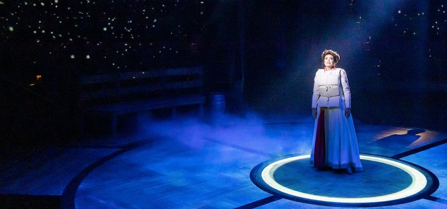 The Unsinkable Molly Brown, Hale Centre (2022) Production photo from The Unsinkable Molly Brown. A woman wearing a white life vest stands alone onstage in a spotlight.