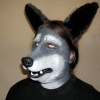 A man wearing a foam latex wolf muzzle prosthetic with makeup and ears