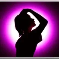 Silhouette of a girl with her hand in her hair surrounded by a purple glowing ring.
