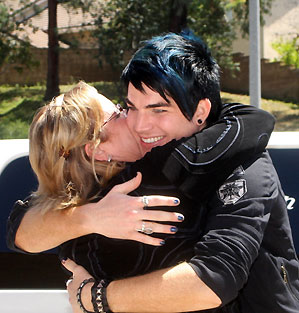 Adam Lambert gets a welcome home hug from Kathie Urban of Met2 in San Diego